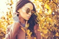 Beautiful lady surrounded autumn leaves