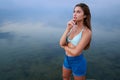 Beautiful lady on tropical island beach with flat mirror glassy water surface. Fashionable tanned woman with slim Royalty Free Stock Photo