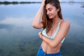 Beautiful lady on tropical island beach with flat mirror glassy water surface. Fashionable tanned woman with slim Royalty Free Stock Photo