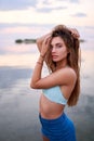 Beautiful lady on tropical island beach with flat mirror glassy water surface. Fashionable tanned woman with slim Royalty Free Stock Photo