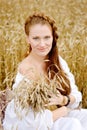 Beautiful lady in wheat field. looking at camera Royalty Free Stock Photo