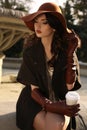 Beautiful ladylike woman in elegant coat and hat drinking coffee Royalty Free Stock Photo