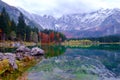 Beautiful Lago di Fusine mountain lake in autumn and Mangart mountain in the background at sunset