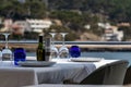 Beautiful laid table in a restaurant overlooking the mediterranean sea with sant elm in the background, mallorca, spain