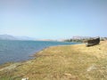 Beautiful lake boat standing blue sky hill background photo Royalty Free Stock Photo