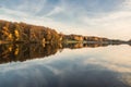 Beautiful lake and colorful forest in autumn evening light. Beautiful forest of colorful autumn trees reflecting in calm lake in D Royalty Free Stock Photo