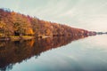 Beautiful lake and colorful forest in autumn evening light. Beautiful forest of colorful autumn trees reflecting in calm lake in D Royalty Free Stock Photo