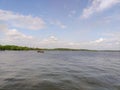 Beautiful lake with a faraway view of a moving boat