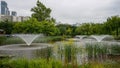 Beautiful lake with fountains, green grass and trees in the nature park in Suel Royalty Free Stock Photo