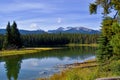 Beautiful lake high in the mountains surrounded by forest. Blue sky, white clouds. Royalty Free Stock Photo