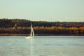 Beautiful lake landscape, yacht, and sunset. Blue waves, boat and horizon line on water. Beautiful background