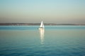 Beautiful lake landscape, yacht, and sunset. Blue waves, boat and horizon line on water. Beautiful background Royalty Free Stock Photo