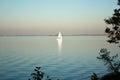 Beautiful lake landscape, yacht, and sunset. Blue waves, boat and horizon line on water. Beautiful background Royalty Free Stock Photo