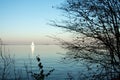 Beautiful lake landscape, yacht, and sunset. Blue waves, boat and horizon line on water. Beautiful background Royalty Free Stock Photo