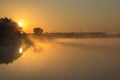 Beautiful lake in the morning mist and rising sun Royalty Free Stock Photo