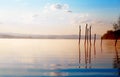 Beautiful lake with mountains in the background at sunrise. Trees in water and morning fog. Royalty Free Stock Photo