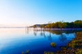 Beautiful lake with mountains in the background at sunrise. Trees in water and morning fog. Royalty Free Stock Photo