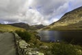 Beautiful lake and Mountains Sun and cloud. Ogwen Cottage, Snowdonia, Wales, wideangle A5 road in foreground Royalty Free Stock Photo