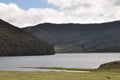 Beautiful lake rolling hills blue sky white clouds