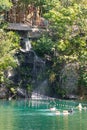 Lake with waterfall, fish and plants at the bottom, it is used for diving, located in a water park.