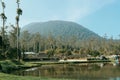 a beautiful lake surrounded by green grass. And there& x27;s Mountain view at back Royalty Free Stock Photo