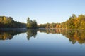 Beautiful lake with trees in autumn color and a small island in northern Minnesota on a calm clear morning Royalty Free Stock Photo