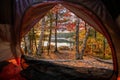 Beautiful lake view at golden hour with fall foliage from the inside of the tent