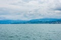 Beautiful lake Zurich landscape. Cloudy skyscape with background of Alps mountains peaks