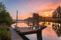 Beautiful lakeside and dock wooden boats at early morning sunrise Royalty Free Stock Photo