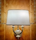 Beautiful lamp - sconce on a wooden brown wall Royalty Free Stock Photo