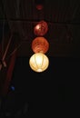 Beautiful lamp shades in the night hanging from the ceiling of the roof