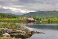 Beautiful landscape along with waters edge, with a village & church & mountains, Bodo, Norway. Royalty Free Stock Photo