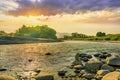 beautiful landscape of amazing sunset on a rough stormy mountain river