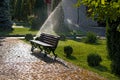 beautiful landscape with automatic sprinkler spraying watering the lawn in the home garden with a rainbow in water drops Royalty Free Stock Photo