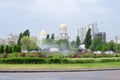 Beautiful landscape with automatic sprinkler spraying watering the lawn in the home garden with a rainbow in water drops close up