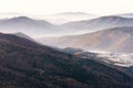 Beautiful landscape of autumn mountains layers range at  hazy morning. A view of the misty slopes of the mountains in the distance Royalty Free Stock Photo