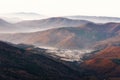 Beautiful landscape of autumn mountains layers range at  hazy morning. A view of the misty slopes of the mountains in the distance Royalty Free Stock Photo