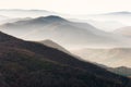 Beautiful landscape of autumn mountains layers range at  hazy morning. A view of the misty slopes of the mountains in the distance Royalty Free Stock Photo