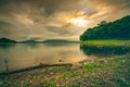 Beautiful landscape of Bang Pra reservoir in the morning with sunrise above the mountain and green tree forest. Cloudy sky Royalty Free Stock Photo