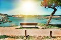 Beautiful landscape of beach and coast with mountains and vegetation. Lonely bench on a cliff facing the sea Cantabria, Spain.