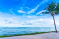 Beautiful landscape of beach sea ocean with coconut palm tree with white cloud and blue sky Royalty Free Stock Photo