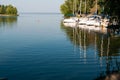 Landscape of berth with white boats on water with reflaction in front of trees in yachts club Royalty Free Stock Photo