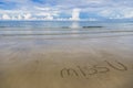 Beautiful landscape of blue sky sea and white waves on beach with words `Miss U` on `White sand beach` of Koh Chang island Royalty Free Stock Photo