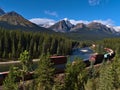 Beautiful landscape in the Canadian Rocky Mountains viewed from popular Morants Curve with train moving past on sunny day. Royalty Free Stock Photo