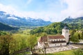 Beautiful landscape with church in Gruyeres,Switzerland. Alps mountains and fields, pretty summer day. Royalty Free Stock Photo
