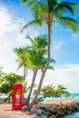 Beautiful landscape with a classic phone booth on the white sandy beach in Antigua Royalty Free Stock Photo