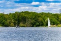 Beautiful landscape at cloudy day with flowing river with two swimming boats on it in front of green trees and bushes Royalty Free Stock Photo