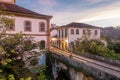 Beautiful landscape of colonial style buildings and old bridge in a cloudy sunset in Ouro Preto, Brazil. Ouro Preto was designed a Royalty Free Stock Photo