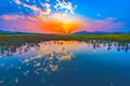 Beautiful landscape with a colorful sunset over a lake with reflected in the water in the countryside Royalty Free Stock Photo
