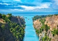 Beautiful landscape of the Corinth Canal in a bright sunny day against a blue sky with dramatic clouds Royalty Free Stock Photo